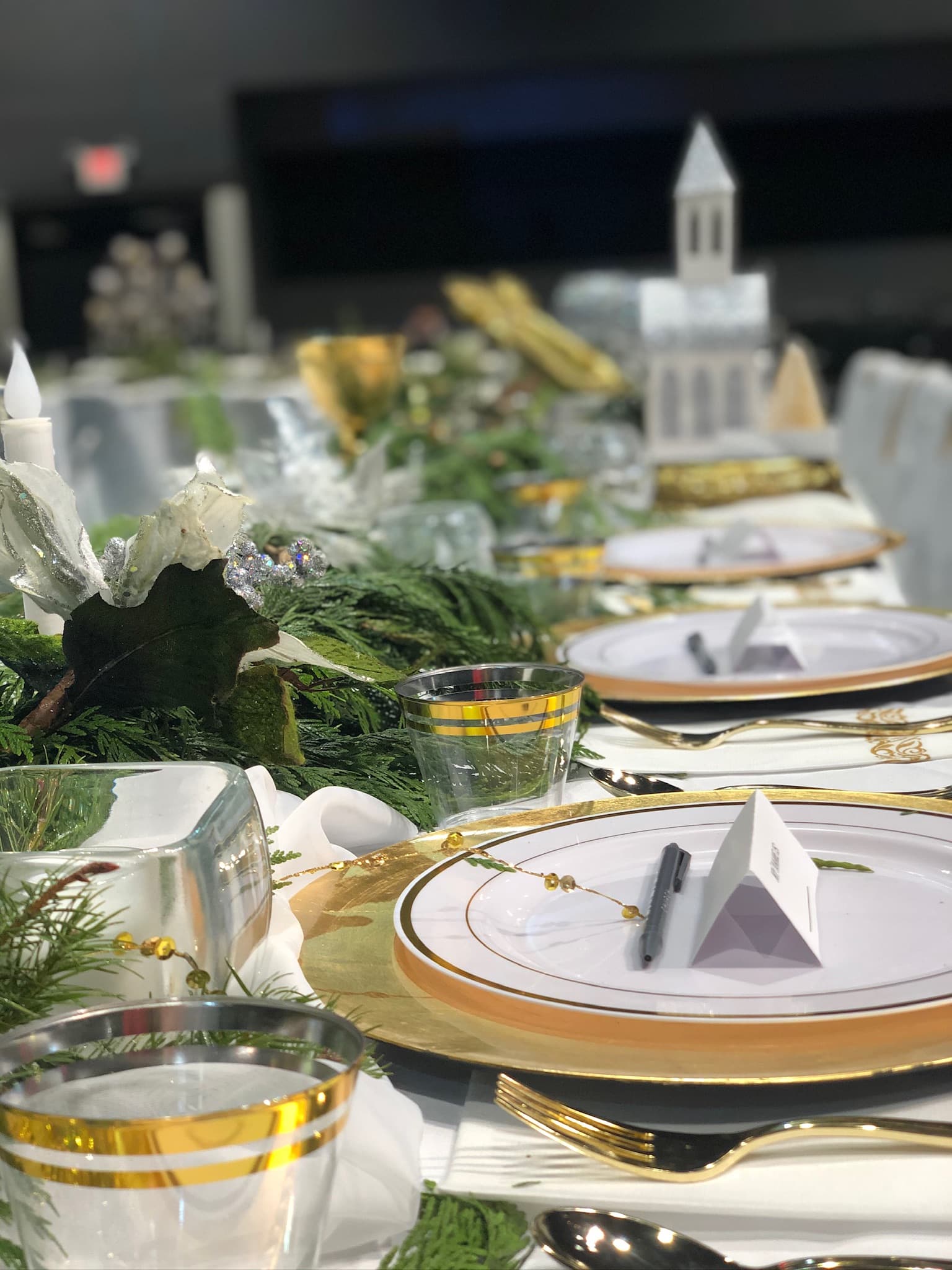 Lush floral centrepiece at a Luxe Collective event — blush roses and trailing greenery on a gilded table